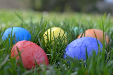 Hiding Colorful Easter Eggs In The Grass For An Easter Egg Hunt.